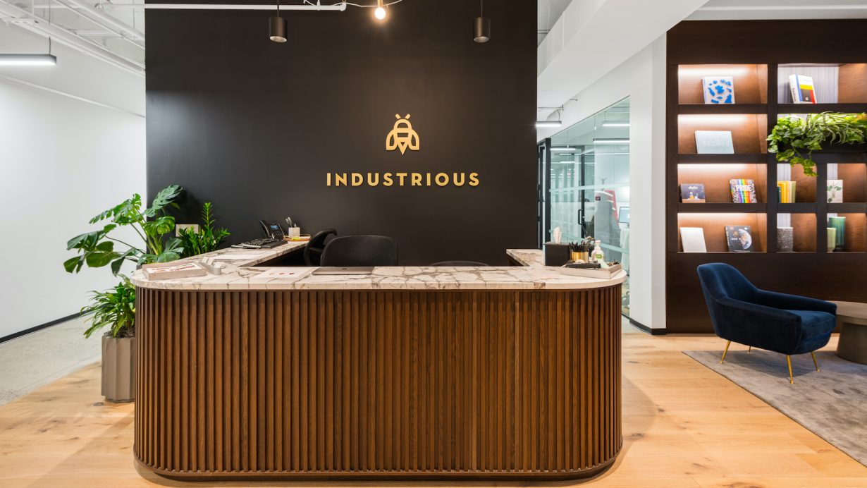 A community manager mans the reception desk, directing visitors and helping members as needed.