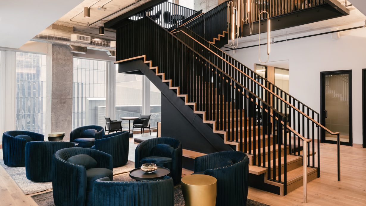 A custom chandelier hovers over the two-story staircase.