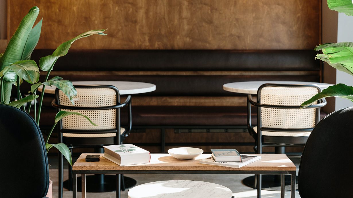 Plants, earth tones, and natural materials like cane can be found throughout Industrious PPG Place.