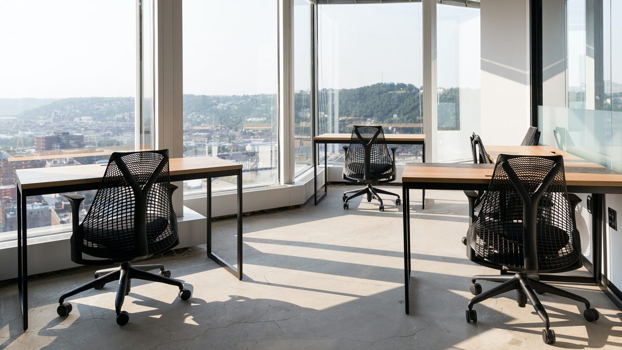 Floor-to-ceiling windows fill private offices and suites with soft, natural light.