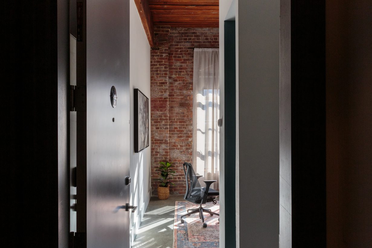 Slatted wood ceilings and exposed brick walls have been preserved from the original building.