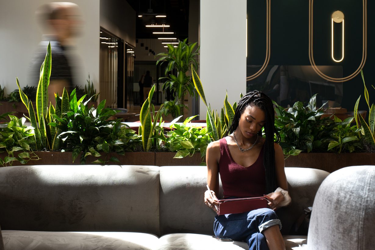 Greenery and chic furnishings fill the member lounge at Industrious Ybor City.